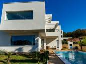 Modern villa with pool and garden in an exclusive location near the sea